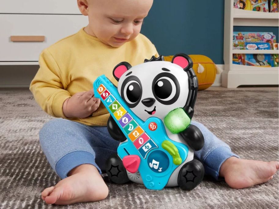 baby playing with Fisher-Price Baby Learning Toy Link Squad Jam & Count Panda on floor