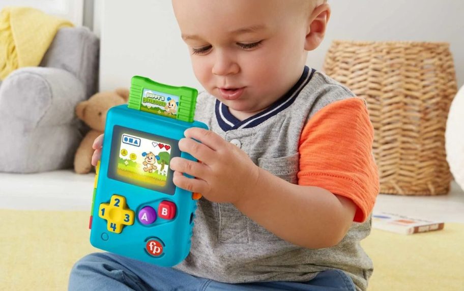 kid playing with Fisher-Price Laugh & Learn Lil' Gamer Pretend Video Game Learning Toy