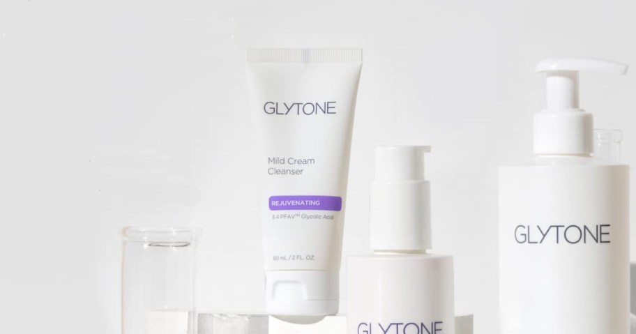 small bottle of Glytone Mild Cream Cleanser near other skincare products