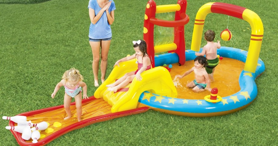 kids playing on colorful inflatable pool with slide