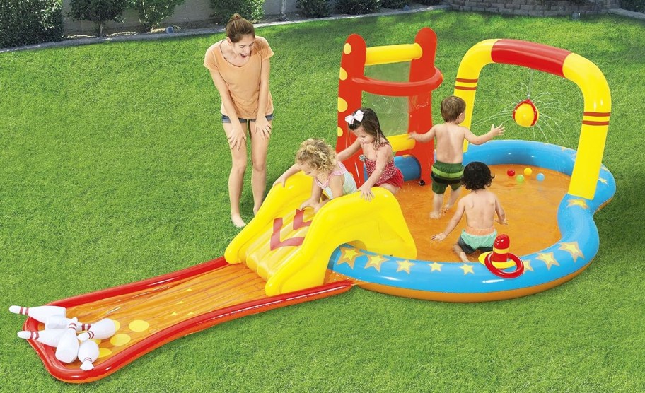 kids playing on colorful inflatable pool with slide