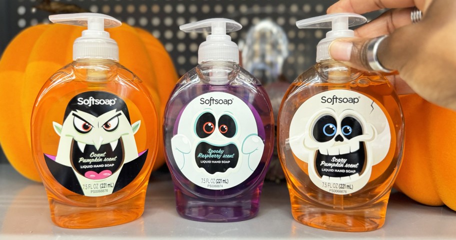 three bottles of Halloween Softsoap hand soap in front of pumpkins