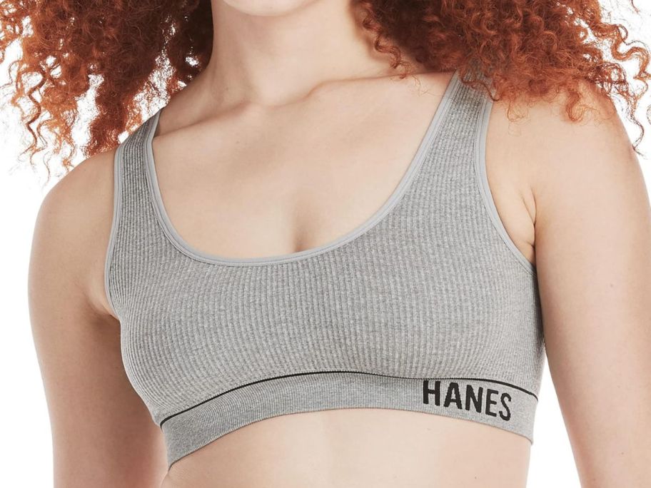 A woman wearing a very comfortable grey sports bralette 