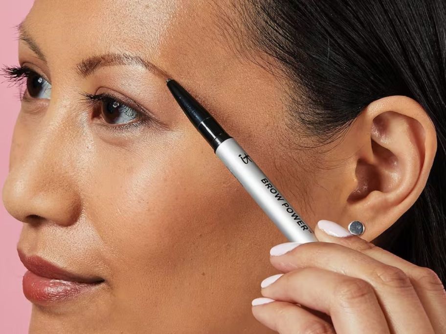 woman using a IT Cosmetics Brow Power Universal Eyebrow Pencil on her brow