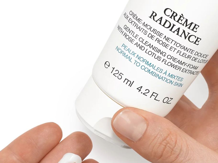 Lancôme Crème Radiance Clarifying Cream-to-Foam Cleanser 4.2oz being squeezed into hand