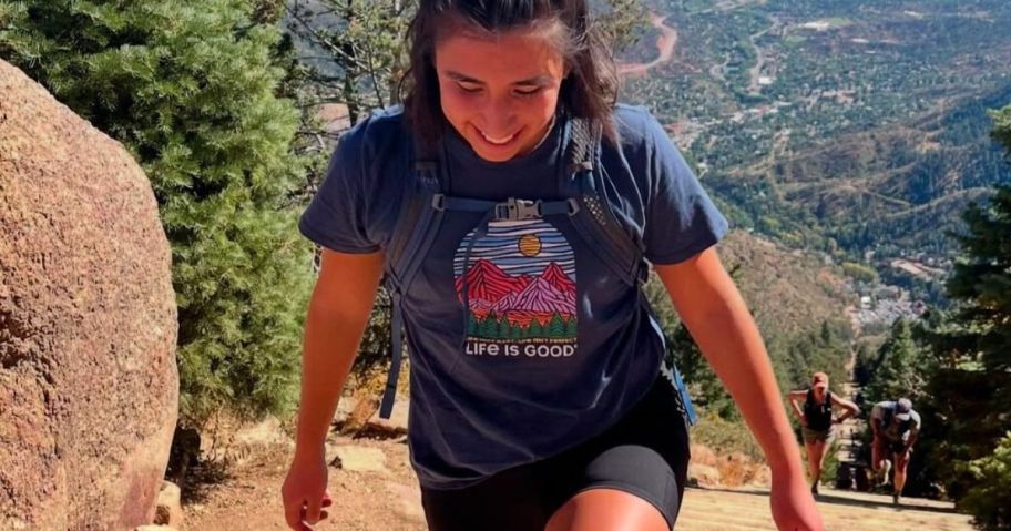 Woman hiking wearing a Life is Good Tee