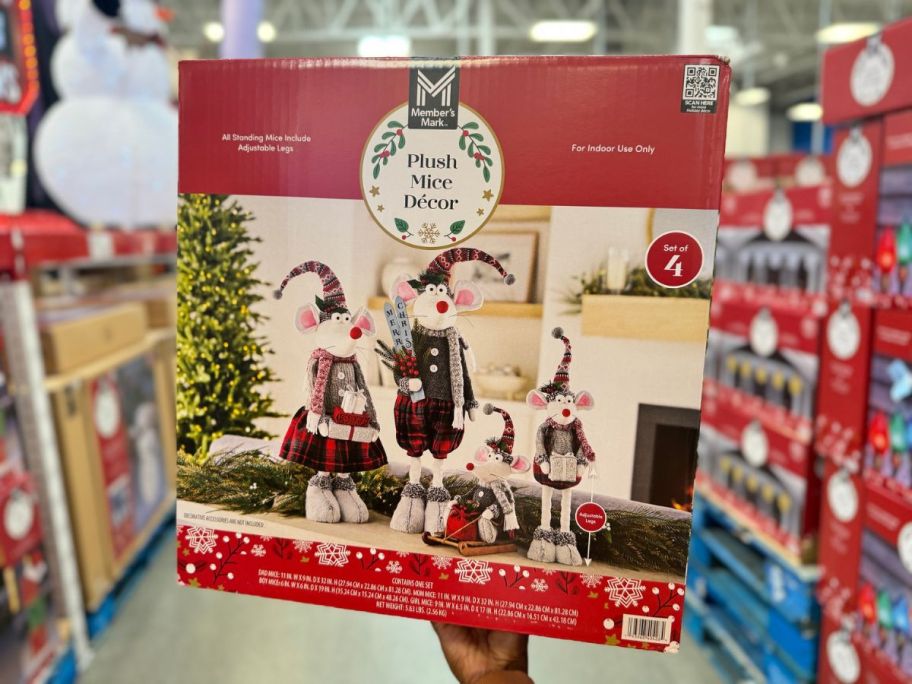 Hand holding up a box with a Member's Mark Plush Christmas Mouse Family Decor Set 