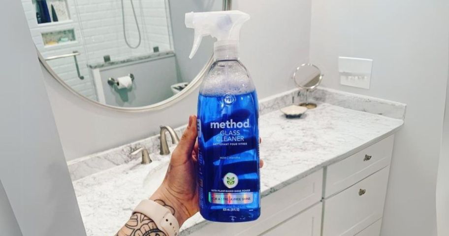 Method Glass Cleaner 28oz in hand in bathroom