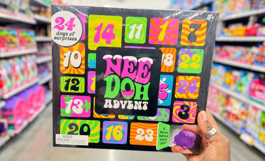 a womans hand holding a nee doh advent calendar