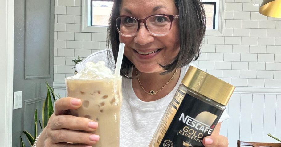 Woman holding a coffee drink and jar of Nescafe Gold Espresso