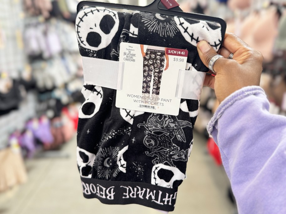 hand holding up a pair of Nightmare Before Christmas pajama pants