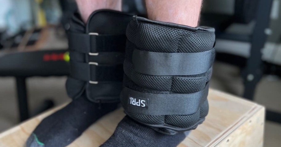 person wearing spri ankle weights in black