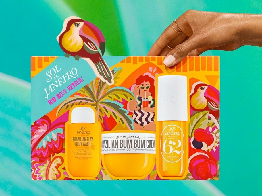 hand holding a yellow boxed Sol de Janeiro gift set