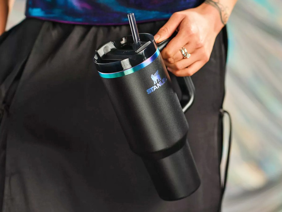 hand holding a Black Chroma Stanley tumbler