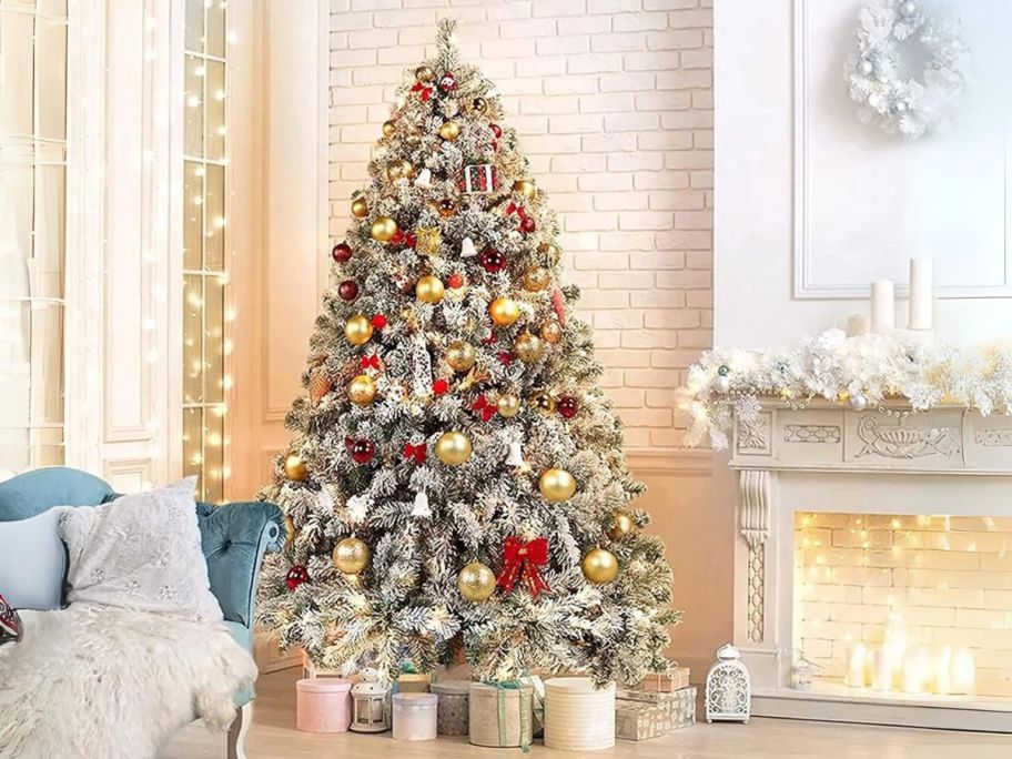 Sugift 6' Snow Flocked Pine Artificial Christmas Tree in living room