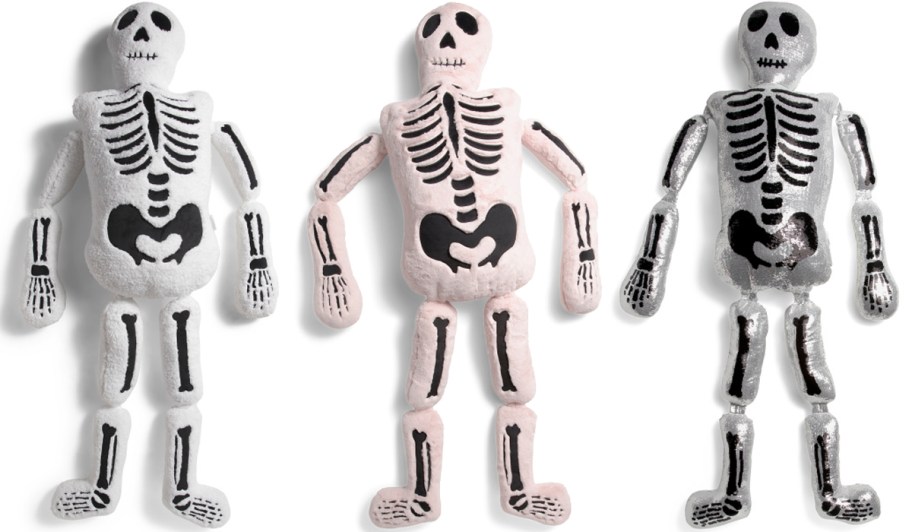 white, pink, and sequined life-size skeleton pillows