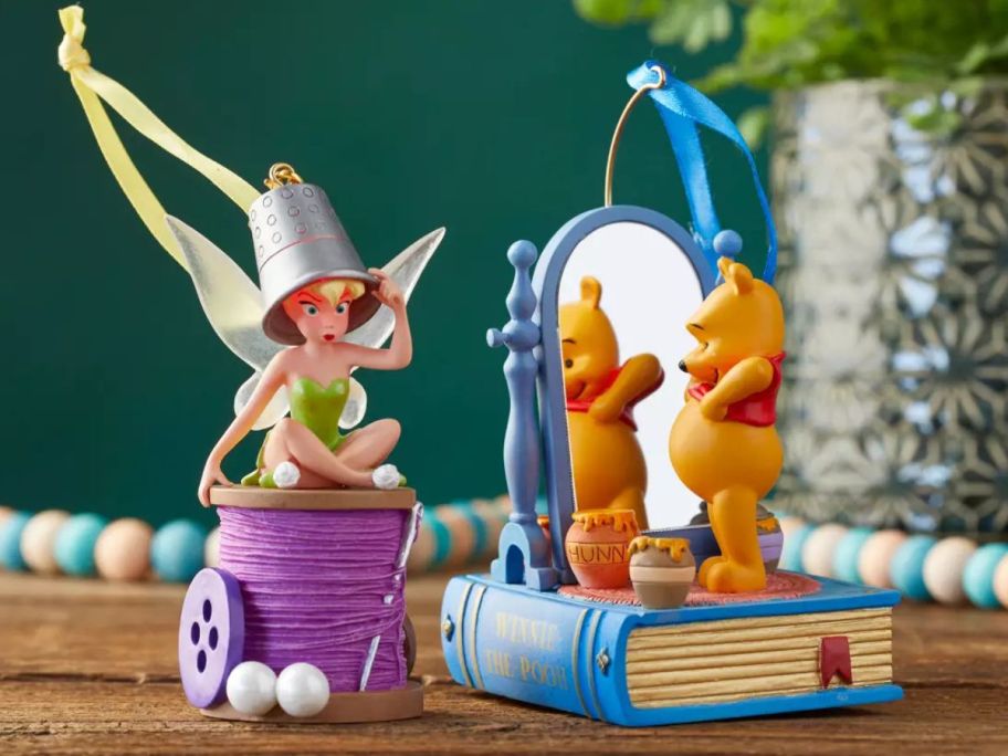 Tinkerbell and Winnie the Pooh Ornaments on a table