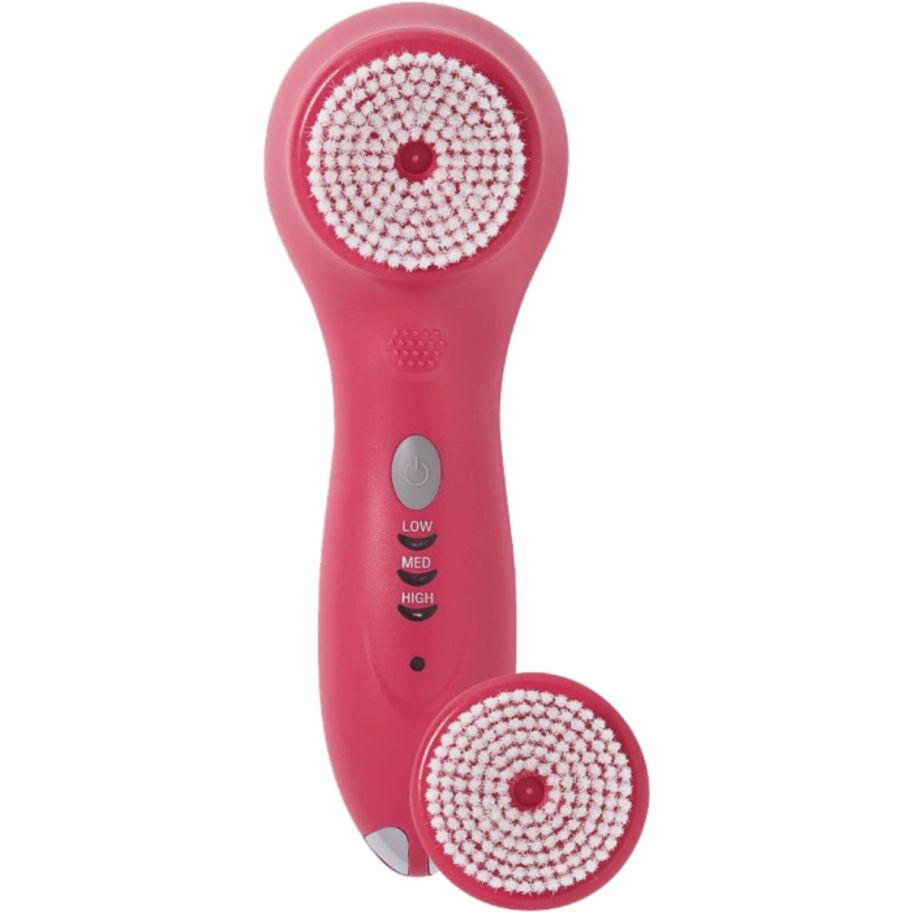 sonic facial brush in pink shown with extra brush head on a white background