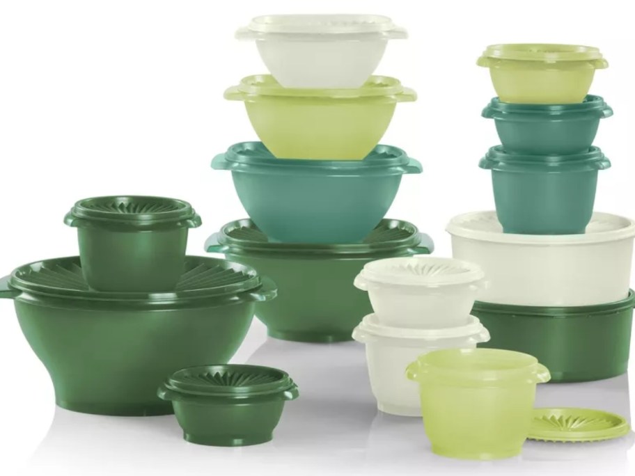 a set of Tupperware bowls in various sizes with classic lids in shades of greens and whites on a white background