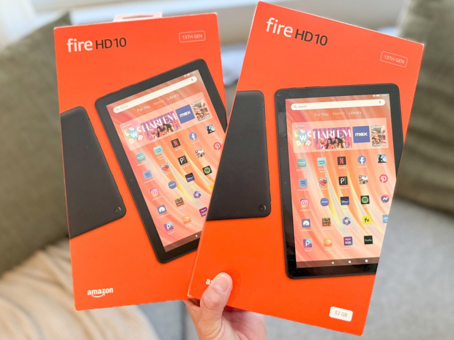 Two Fire HD tablets in hand