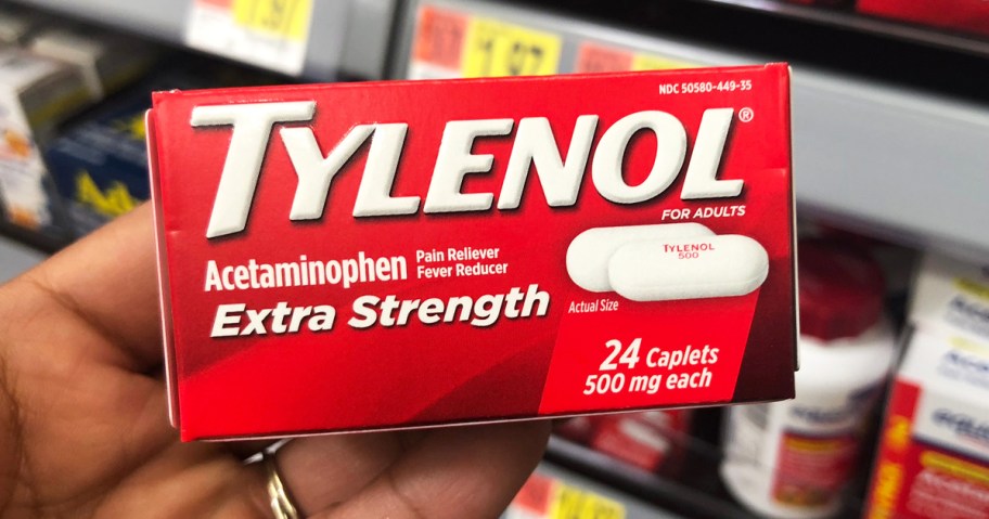 hand holding a red box of Tylenol Extra Strength Caplets