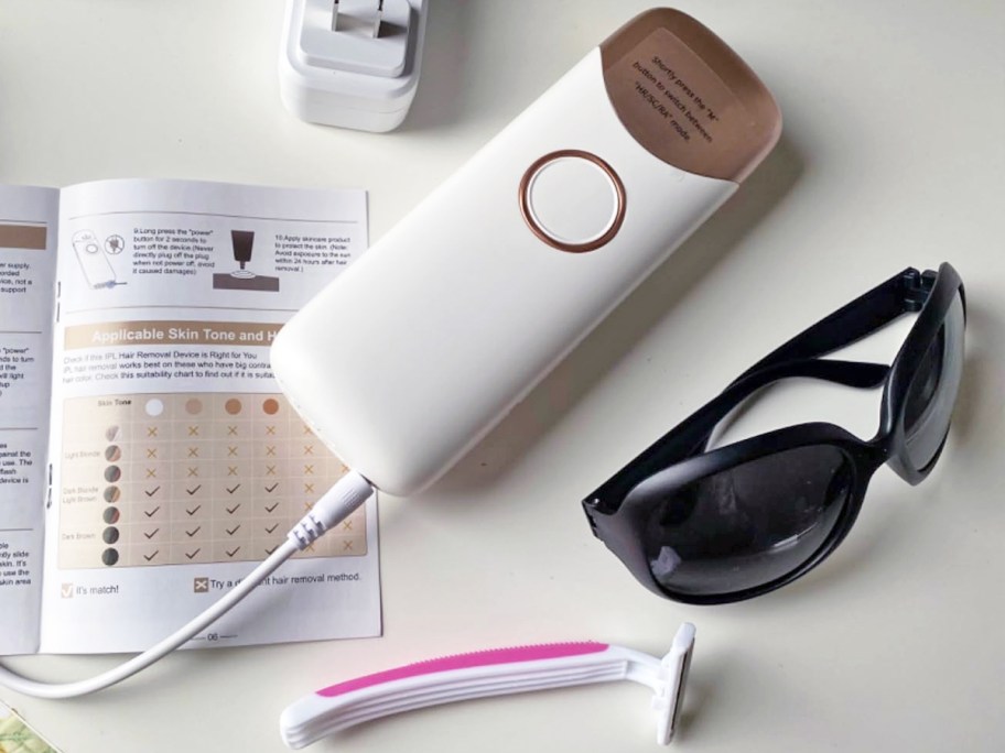 ipl device with user guide, sunglasses, and razor