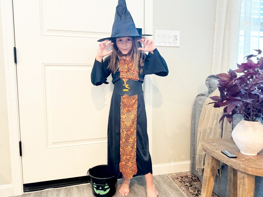 girl in a black and orange witch costume