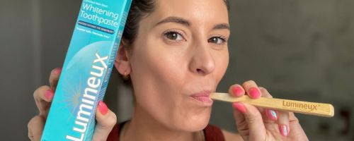 Woman using lumineux whitening tooth paste