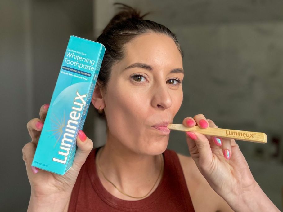 Woman using lumineux whitening tooth paste