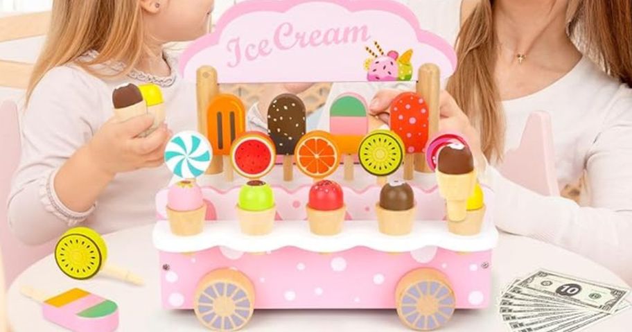 A child and an adult playing with a Wooden Montessori Ice Cream Playset