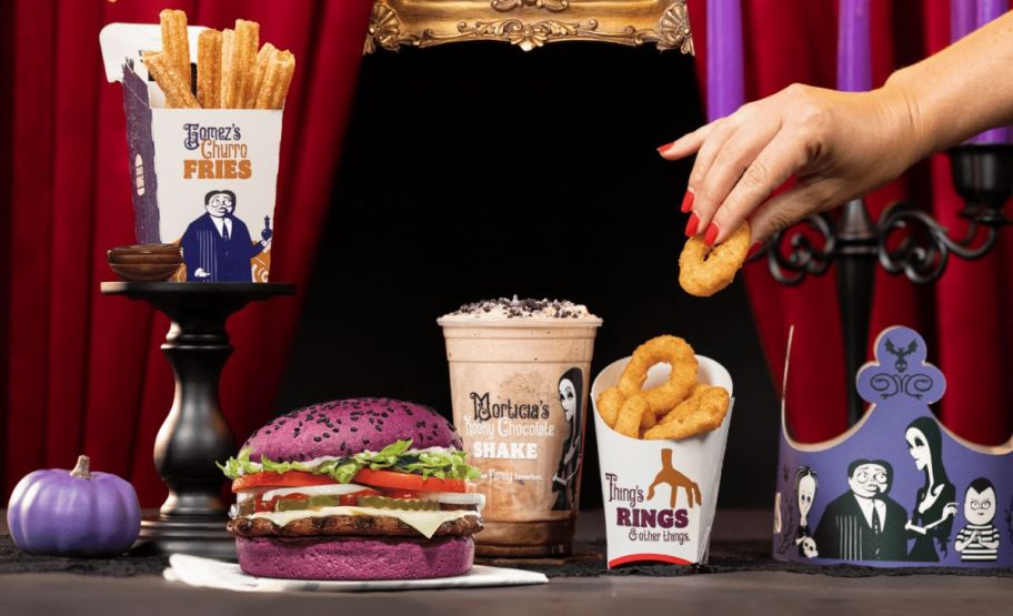 Burger King Addams Family menu items shown with a womans hand grabbing an onion ring