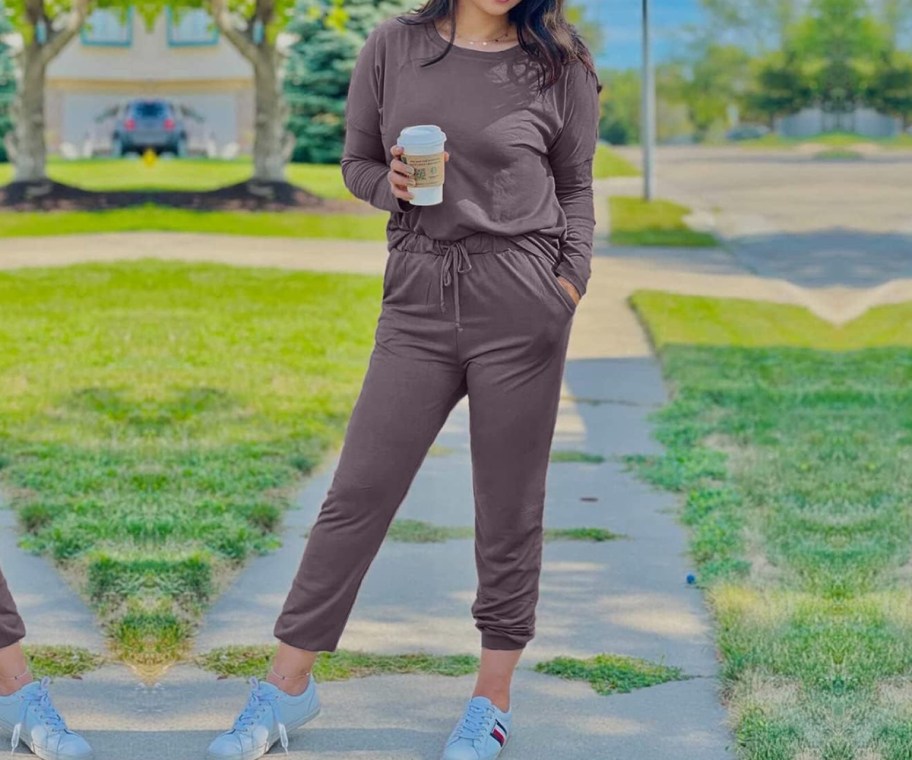 woman holding coffee cup in taupe 2-piece outfit