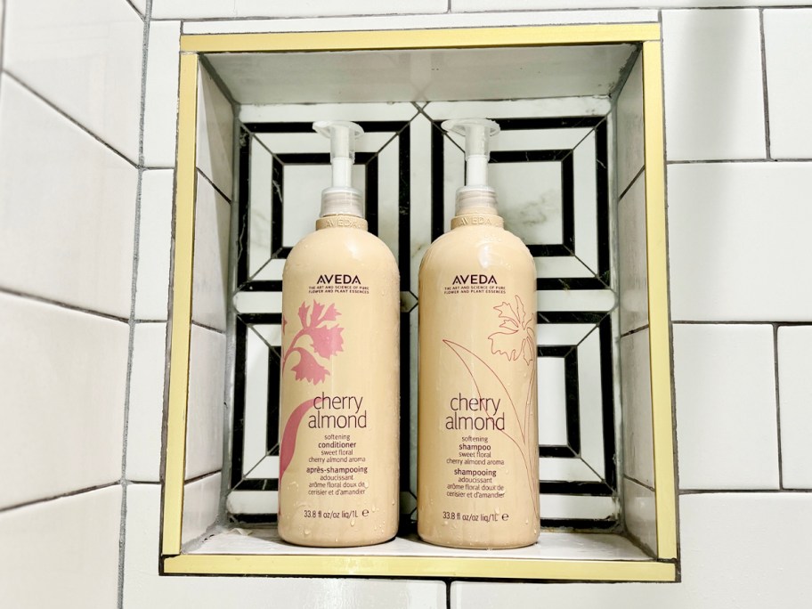 aveda shampoo and conditioner bottles in shower cubby