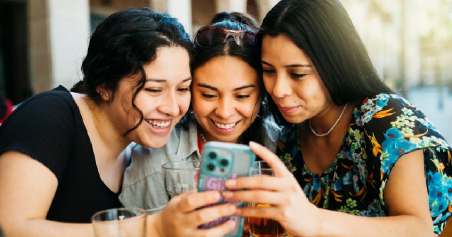 three girls looking at phone