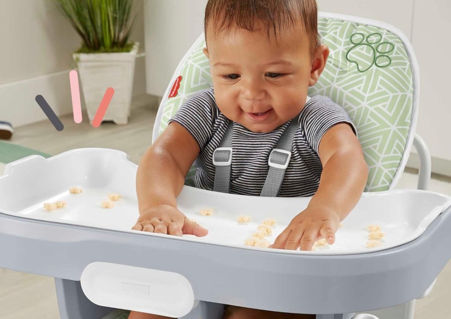 baby on highchair eating cereal