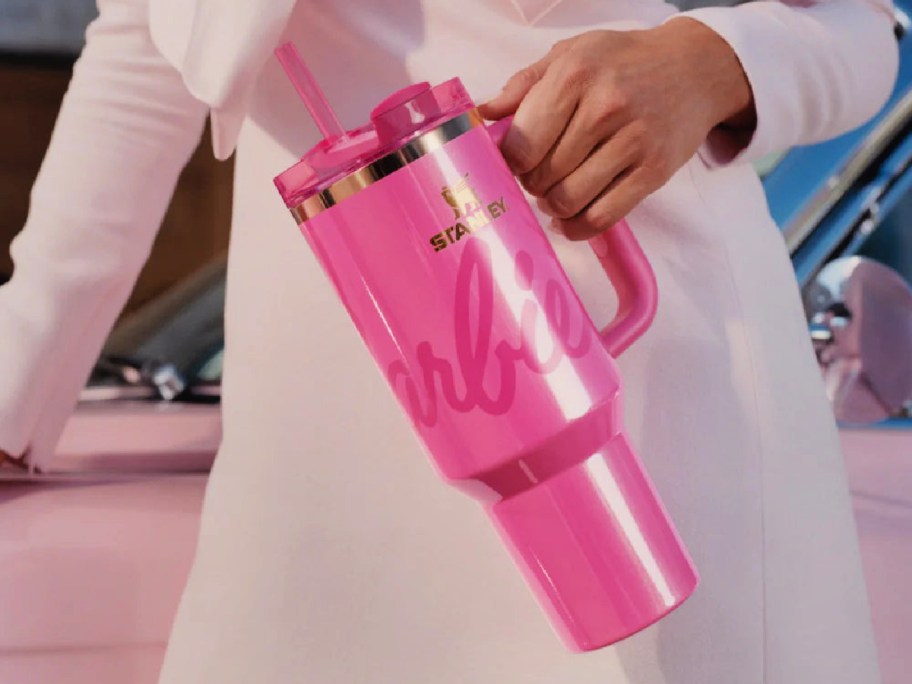 woman holding a pink barbie stanley tumbler