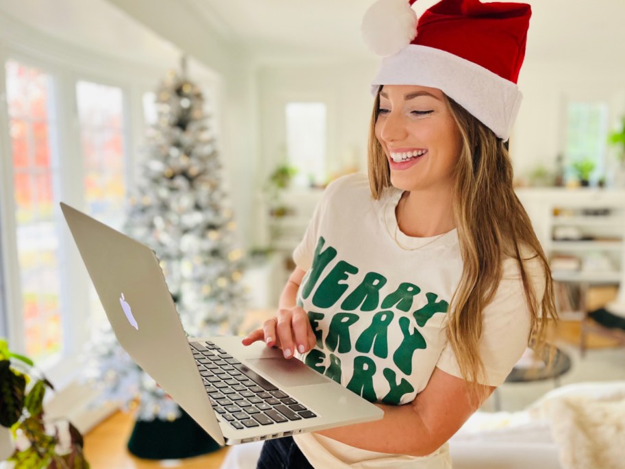 woman in santa hat on laptop