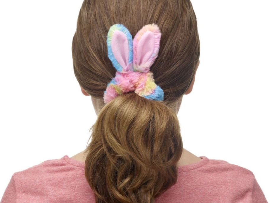 Back of a girl's head wearing a Build-A-Bear bunny scrunchie
