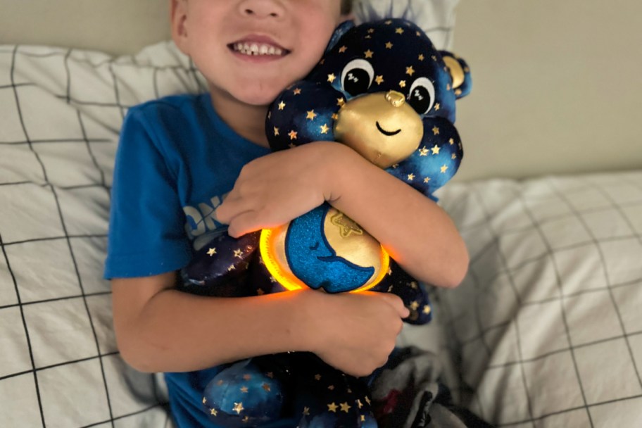 boy hugging light up care bear