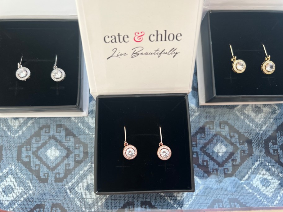 three pairs of earrings in boxes