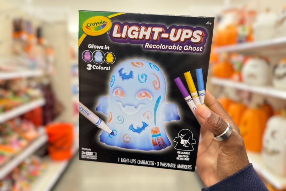 a womans hand displaying a crayola light-ups ghost