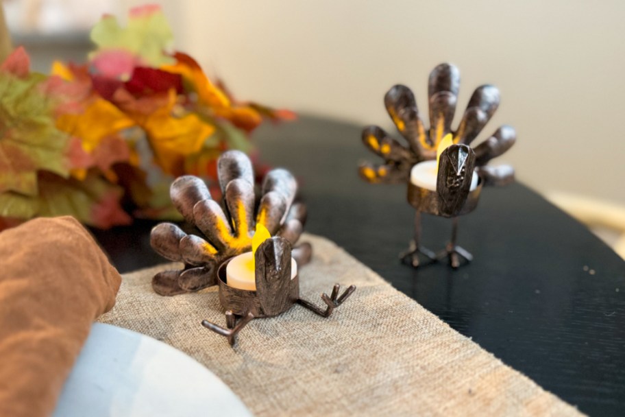 two metal turkey tealight holders