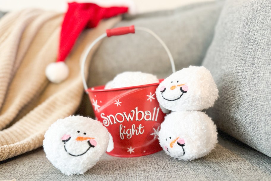 red tin with plush snowballs