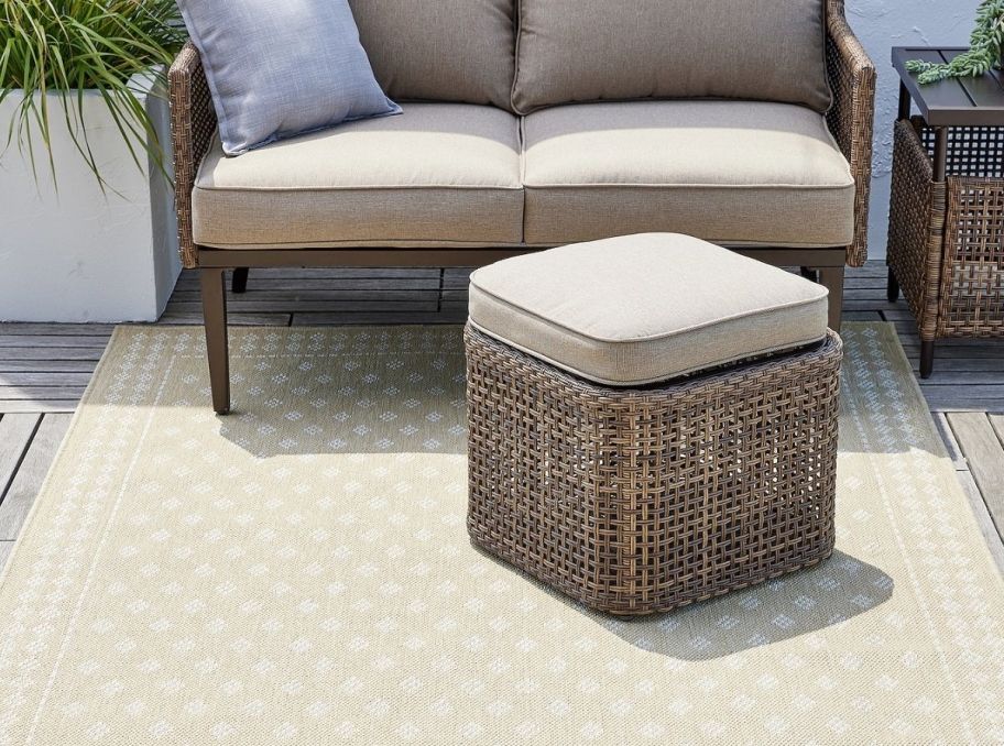 a diamond patterened indoor outdoor rug on a patio