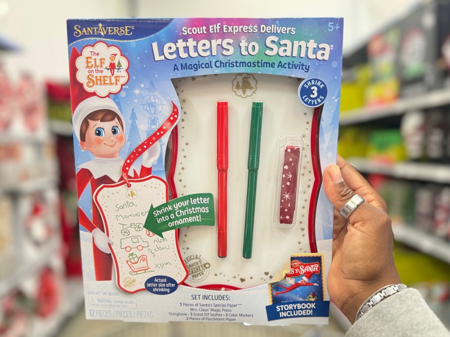 hand holding elf on the shelf letters for santa kit