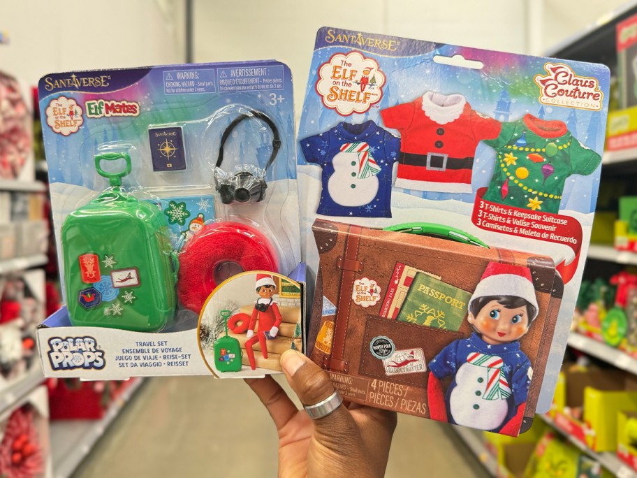 hand holding two travel elf on the shelf kits 