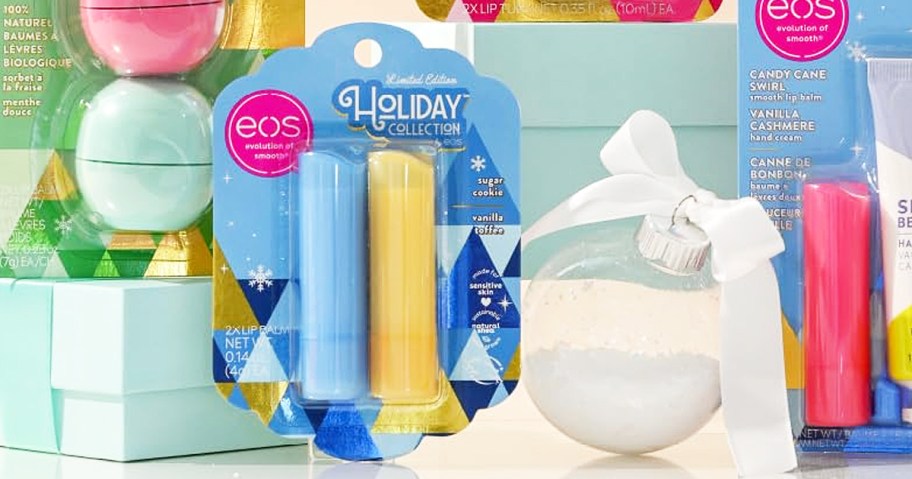 pack of eos Holiday Lip Balms near white ornament with a bow