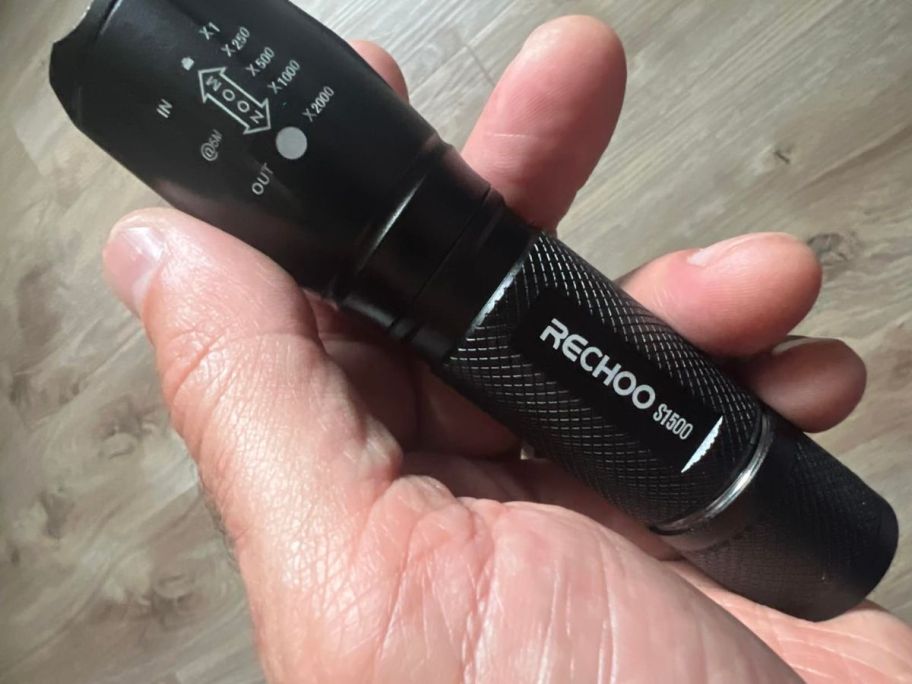 hand holding RECHOO Tactical Flashlight