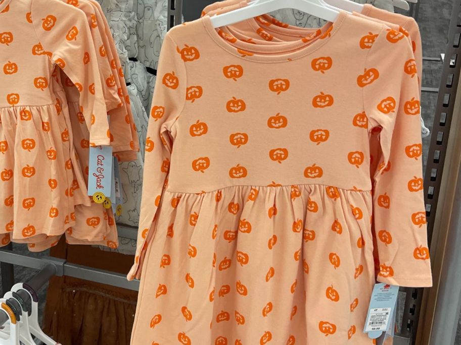 Cat & Jack Toddler Girls Long-Sleeve Halloween Pumpkin Dress hanging in store