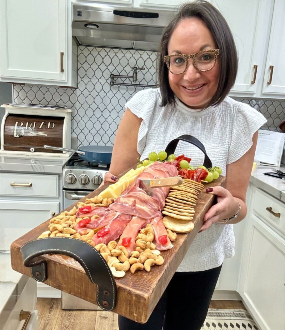 woman holding halloween charcuterie board